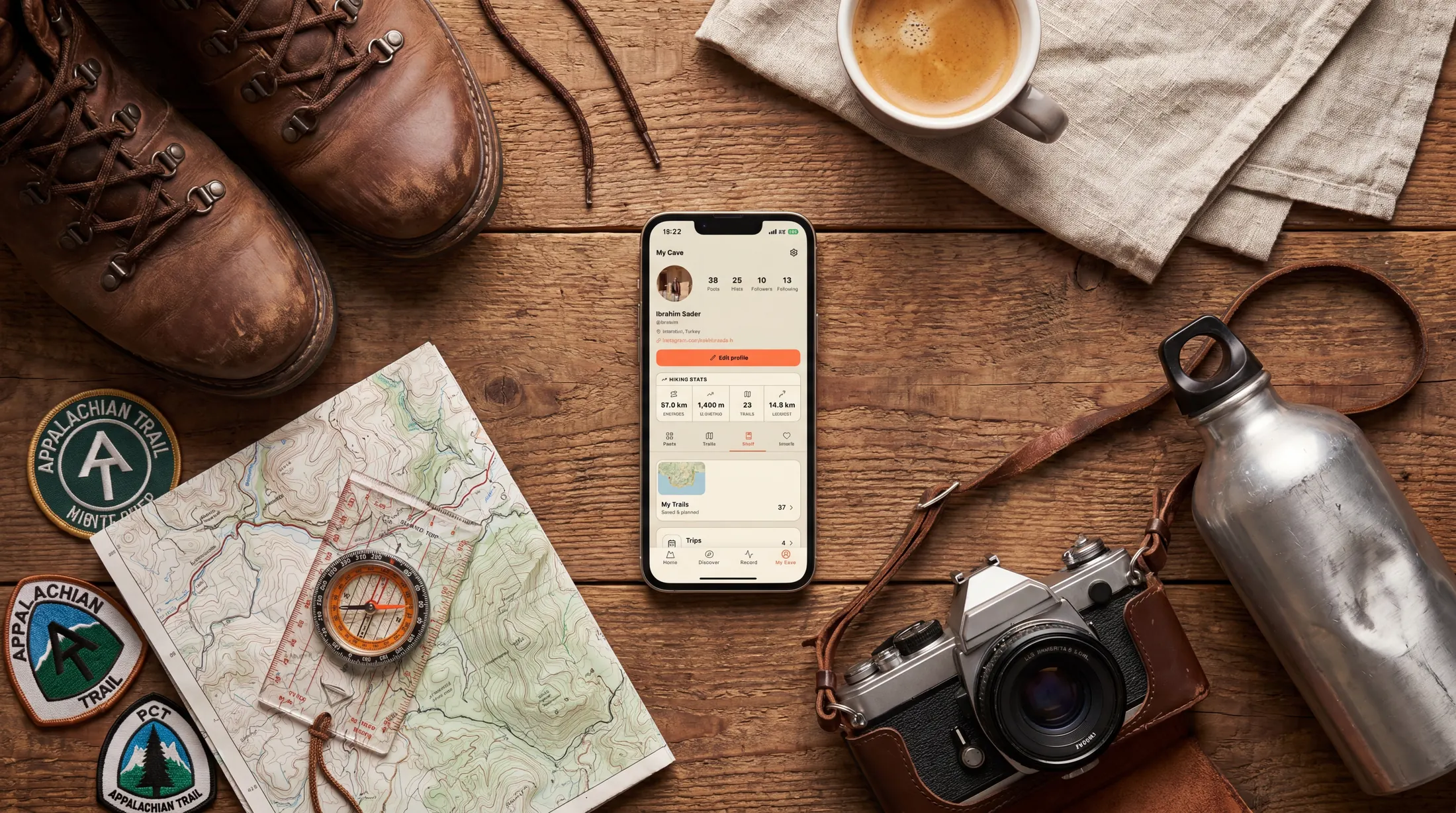 A Outest profile and saved hiking shelf shown on a phone beside hiking gear.